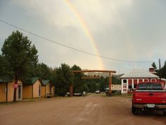 a red truck parked in front of a rainbow