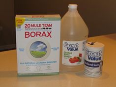 two bottles of borax are sitting on a table next to a carton of yogurt