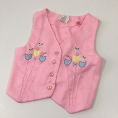 Vintage toddler vest, likely from the early 90's. The vest is pink with v neck. It buttons down the front. It has adorable tulip appliqués on the front. There is a bit of elastic gathering at the back.  In very good vintage condition  Size 2T Measurements  Armpit to armpit- 9.5-11 inches  Length- 11 inches 90s Vest, Toddler Vest, Floral Vest, Floral Vests, Vintage Toddler, Kawaii Fashion Outfits, Vintage Easter, Really Cute Outfits