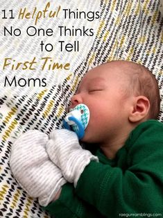 a baby laying on top of a bed with a pacifier in it's mouth