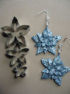 two snowflake shaped cookie cutters sitting next to each other on a table