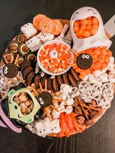 a platter filled with candy, candies and halloween treats on top of a table