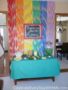 there's no place like home at the end of this table with colorful paper streamers on it