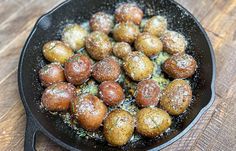 a skillet filled with food on top of a wooden table