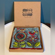 an open box with decorative designs on it