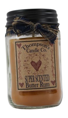 a glass jar with a label on it that says, super scented butter rum