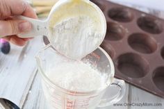 a person mixing batter in a measuring cup