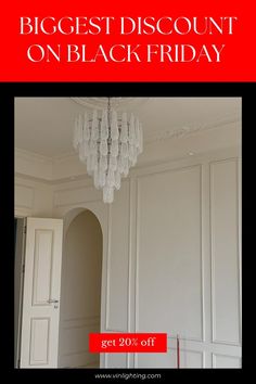 a chandelier hanging from the ceiling in a room with white walls and doors