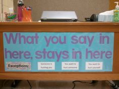 a desk with a sign that says what you say in here, stays in here