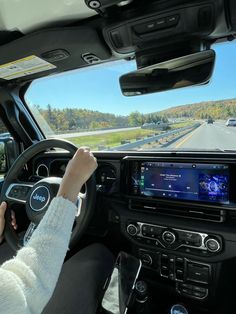 a woman driving a car on the highway