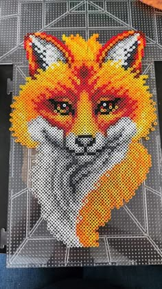 a close up of a piece of art with a fox on it's face