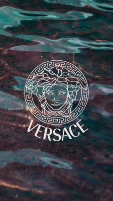 the versa logo is reflected in water with ripples on it's surface, as seen from above