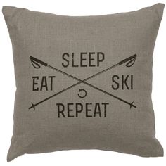 a pillow that says sleep eat ski repeat with two crossed oars on the front