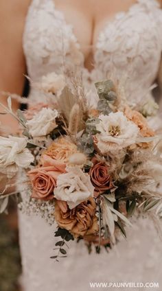 a bride holding a bouquet of flowers in her hands