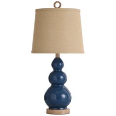 a blue table lamp with a beige shade