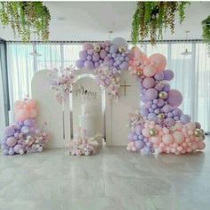 an arch made out of balloons and flowers