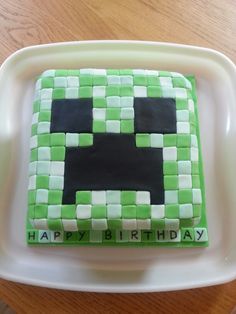 a birthday cake made to look like an 8 - bit video game character on a plate