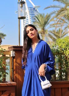 Azure blue georgette silk kaftan with details on the neckline, sleeves and back. Blue Silk Kurta For Summer, Blue Dresses With Cape Sleeves For Eid, Summer Blue Georgette Kurta, Blue Georgette Kurta For Summer, Elegant Silk Tunic For Eid, Blue Silk V-neck Kaftan, Traditional Blue Kurta With Embroidered Neckline, Blue Traditional Kurta With Embroidered Neckline, Blue Georgette Blouse For Summer