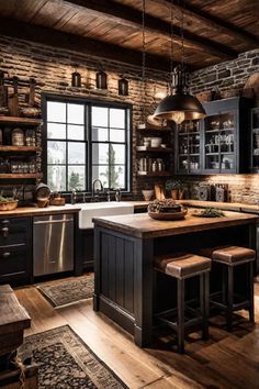 a rustic kitchen with black cabinets and wooden floors, an island in the middle is flanked by two stools