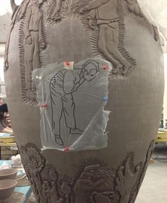 a large vase with some drawings on it