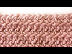 a close up view of a pink knitted blanket