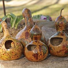 three vases sitting on top of a stone slab