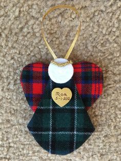 an ornament is hanging on the carpet with a plaid necktie and heart