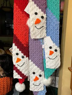 crocheted snowmen hanging from the ceiling