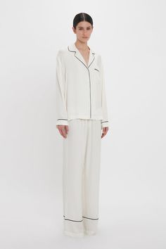 Exquisitely cut from tactile 100% silk, the Pyjama Sleep Set in nostalgic Ivory is an elevated sleepwear and loungewear option. An all-over VB house monogram print imbues the co-ord with its distinct personality, while the luxurious fabrication ensures comfort and ease of movement. The set comes with a tote bag and eye mask in a matching print. Victoria Beckham VB Monogram Pyjama Sleep Set In Ivory  - Size XL UK Luxury Silk Long Sleeve Sleepwear, Luxury Long Sleeve Silk Sleepwear, Elegant Silk Sleepwear With Relaxed Fit, Cream Silk Sleepwear, Elegant Cream Sleepwear For Home, Elegant Long Sleeve Cream Sleepwear, White Silk Long-sleeve Sleepwear, White Silk Long Sleeve Sleepwear, Elegant White Sleepwear For Loungewear