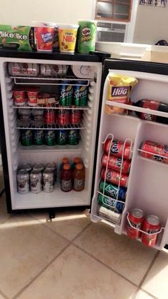 an open refrigerator with drinks and sodas in it