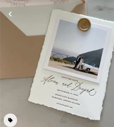 an envelope with a wedding photo attached to it next to a couple's car