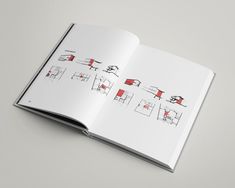 an open book with red and black drawings on the pages, showing different furnitures