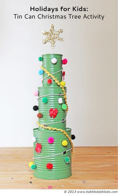 a christmas tree made out of tin cans with the words holidays for kids tin can christmas tree activity