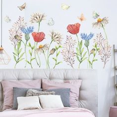 a bedroom with flowers and butterflies painted on the wall