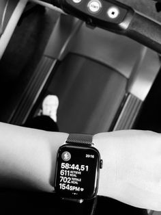 a black and white photo of a person's arm with an apple watch on it