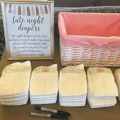 baby diapers are laid out on a table next to a basket with a sign that says late night diapers