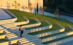 a woman is walking down some steps in the evening