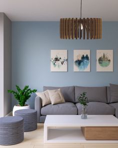 a living room filled with furniture and paintings on the wall above it's coffee table