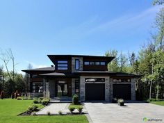 a large house with two garages and lots of windows