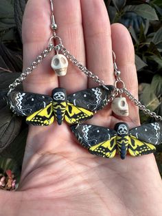 two yellow and black moths on a chain