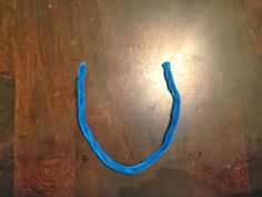 a piece of blue string sitting on top of a wooden table