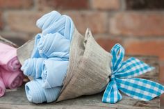 two cloth diapers are sitting next to each other on a wooden table with blue and pink ones