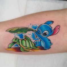 an arm with a cartoon character and turtle on it