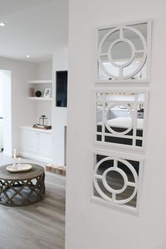 a living room filled with furniture and white walls