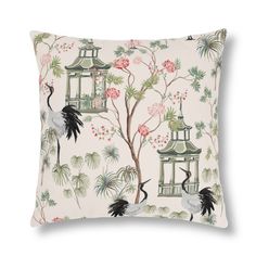 a decorative pillow with birds and pagodas on the front, along with pink flowers