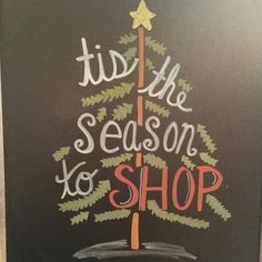 a chalk board with the words tis the season to shop written on it and a christmas tree