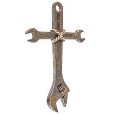 an old style metal cross with two wrenches hanging from it's side on a white background