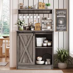 an open cabinet with coffee cups on it in a living room next to a potted plant