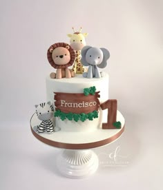 a three tiered cake with animals on top