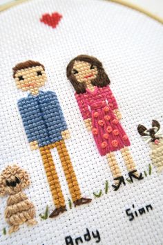 a cross - stitch picture of two people and their dog, with the words i love you on it